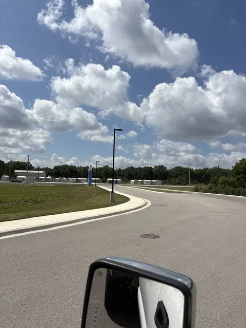 Mowed turf along a curved commercial entrance road