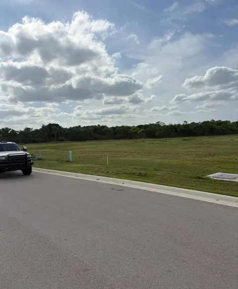 Large open field cut short beside a new road
