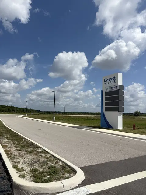 Clean-edged median and mowed turf at a commercial entrance sign