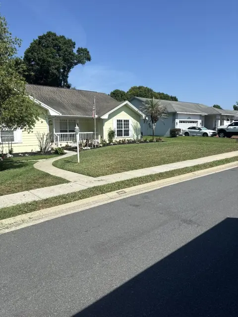 Mowed and edged front lawn and walk on a residential street